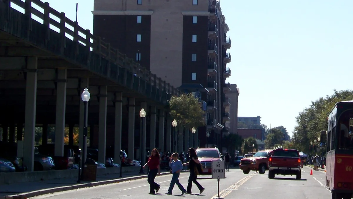 Water Street in downtown Wilmington with parked vehicles beneath the riverfront structure